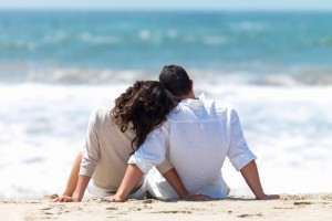 Rear view of a couple sitting on beach